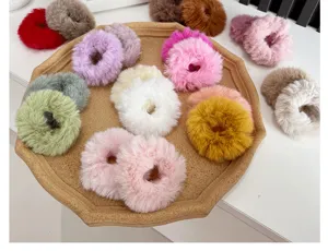Vibrant collection of colorful plush fuzzy hair ties displayed on a rustic tray