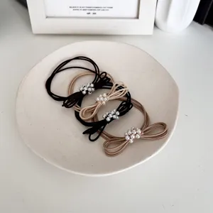 Set of elegant pearl bow elastic hair ties in black and beige for women's hair styling