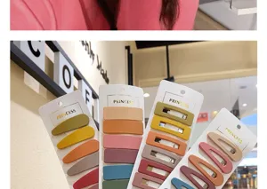 Close-up detail of matte hair clips set in various earthy colors on white cards