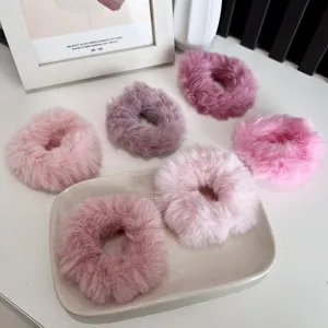 Soft fuzzy faux fur hair scrunchies in assorted pink and purple shades for winter.