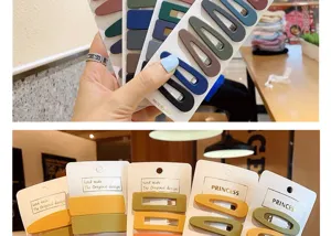 Detailed macro view showing assorted colorful matte hair clips on original design cards