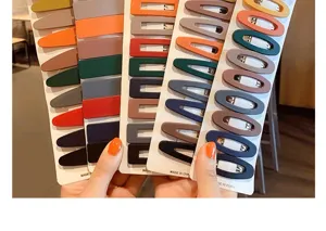Selection of colorful matte snap hair clips in various geometric shapes on display cards