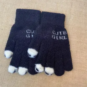 Detail view of cute women winter knit gloves with cat paw fingertips and soft warm lining.