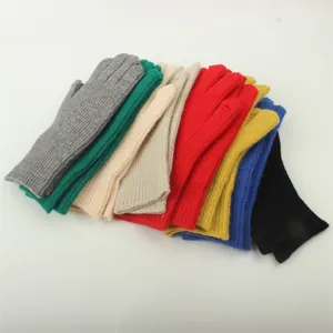 Detailed shot of colorful knitted fingerless gloves set, warm winter fashion style.