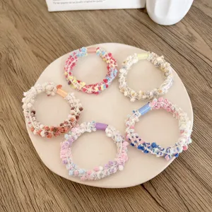 High elastic colorful textured hair ties set for women displayed on a ceramic plate