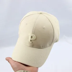 Beige baseball cap with embroidered letter P detail, perfect for daily outdoor sun protection.