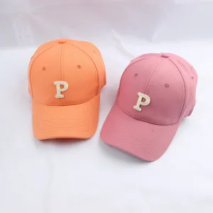 Detailed view of women's colorful baseball cap with embroidered letter P, breathable sun hat.