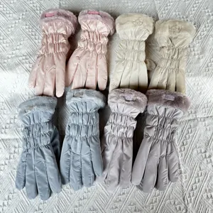 Detailed view of women winter warm thick gloves, plush furry cuffs, soft down cotton padding.