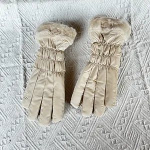 Detailed view of women winter warm thick down cotton gloves with plush cuff and cute bear tag.