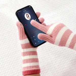 Pink white striped fingerless knit gloves winter warm wool gloves, detail view of cozy wear.