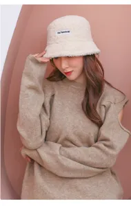 Winter cozy sherpa bucket hat for women, cute fleece fuzzy cap with text patch, warm outdoor.