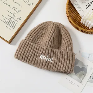 Cozy brown knit beanie for women, thick warm winter hat with cute white embroidered letters.