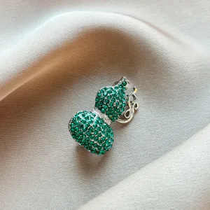 Exquisite green rhinestone gourd brooch close-up, elegant Chinese style clothing accessory detail.