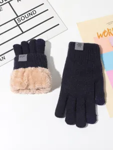 Detailed view of winter warm knitted gloves with plush cuffs and touch screen design for cold days.