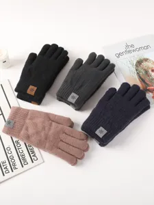 Detailed view of winter knitted gloves in multiple colors displayed with lifestyle props.