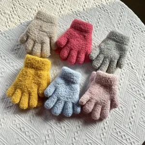 Colorful plush knitted winter gloves detail shot, soft warm five finger thermal design.