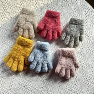 Close-up of kids winter warm knit gloves, soft thick material, multi-color display detail.