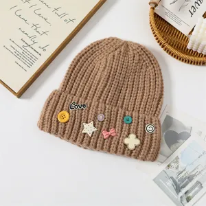 Cute knitted beanie for women, cozy winter warm hat with sweet decorative pins and buttons.