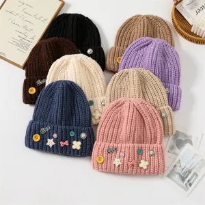 Cute knit beanie hat for women winter warm thick wool cap with sweet badge decorations.