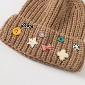 Thickened warm knitted beanie for women, cute decorative charms and stylish winter hat design.