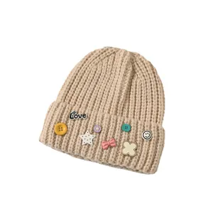 Sweet cute knit beanie hat with decorative pins and buttons for women warm winter wear.