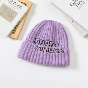 Purple knitted beanie hat with black embroidered letters, cozy autumn winter warm cap.