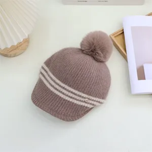 Detailed view of the Japanese style striped knitted hat with warm pom-pom and cozy fit.