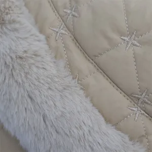 Detail view of winter plush ear-flap fisherman hat, quilted star embroidery and soft faux fur.