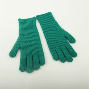 Detailed view of women winter green knitted ribbed gloves, soft and warm texture for cold days.
