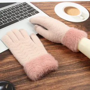 Women winter touch screen knitted gloves with plush warm cuffs detail view on desk