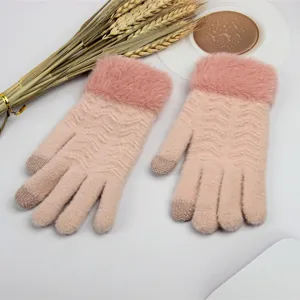 Close-up detail of winter women knit touchscreen gloves with soft fluffy plush cuffs and warm design.