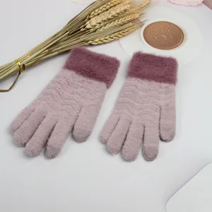 Detail view of plush cuff winter touchscreen knitted gloves in soft pink warm wear.