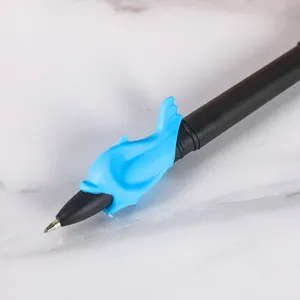 Close-up of a black ballpoint pen featuring a cute blue dolphin silicone grip for comfortable writing.