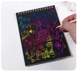 Close-up of hand scratching colorful patterns on black DIY scratch art notebook