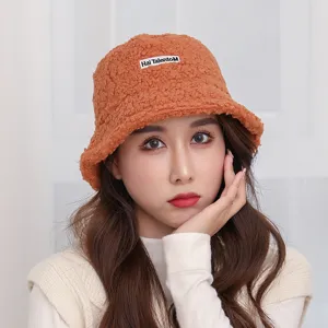 Women orange shearling bucket hat cozy winter outdoor fuzzy plush hat with letter patch.