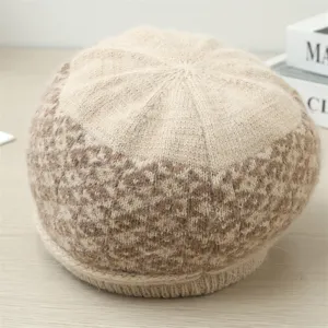 Detailed view of winter knitted beret with leopard pattern, soft fluffy texture and warm fabric.