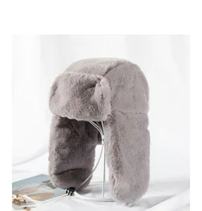 Faux fur bomber hat detail view, soft plush ear flap design, cozy winter gray warm hat close up.