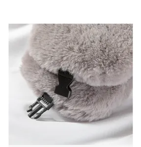 Close-up detail shot of grey plush ear protection winter trapper hat with black buckle.