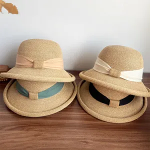 French straw sun hat with elegant bow and rolled edge, perfect for summer outdoor style.