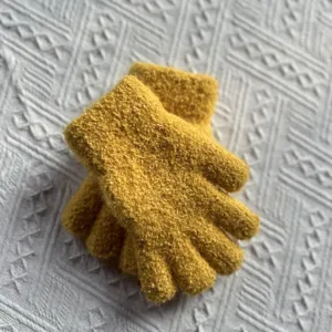 Detailed view of kids winter warm knit gloves, soft yellow wool material for cold weather.