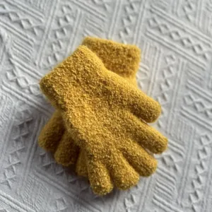 Thickened knitted winter gloves detail shot, soft warm wool texture for kids daily wear.