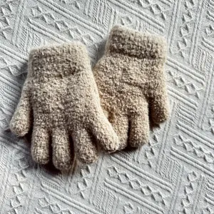 Detailed view of kids warm winter knit gloves, soft fuzzy texture, cozy and comfortable.