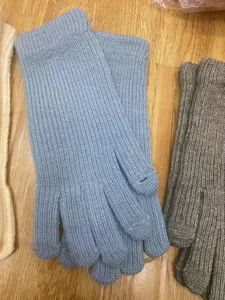 Women winter warm knitted gloves with extended wrist and touchscreen finger holes detail view.