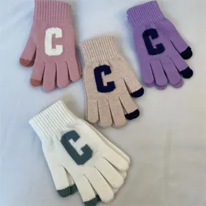 Vue détaillée de gants tricotés d'hiver chauds tactiles avec un design de lettre C.