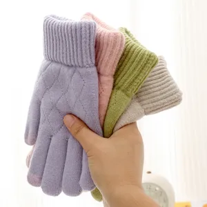 Detailed view of women's winter warm knitted touchscreen gloves with diamond pattern.