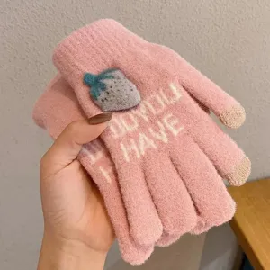 Pink knit touchscreen gloves detail view with cute strawberry decor and cozy winter fabric.