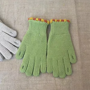 Knit fingerless gloves detailed view, green winter warm knitwear apparel accessory.