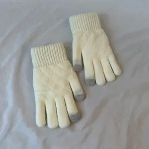 Detailed view of women's warm winter knitted touchscreen gloves with diamond pattern design.