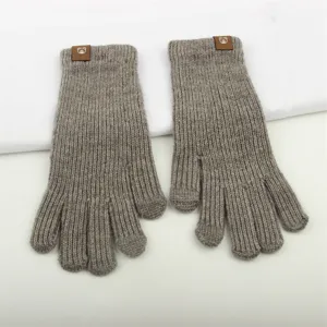 Detailed view of winter knitted gloves, ribbed texture and cute bear patch cuff design.