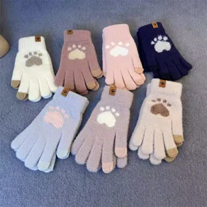 Close-up of cute cat paw knitted touchscreen gloves, thick warm winter thermal gloves details.